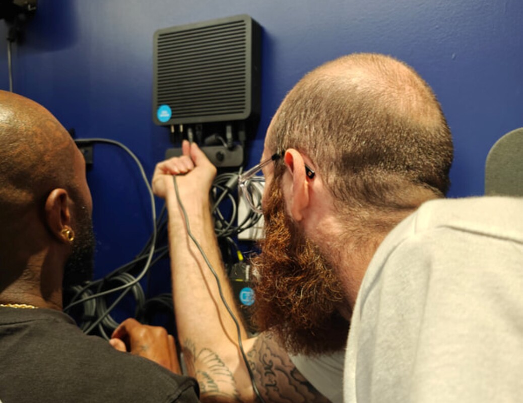 Two GTS technicians installing network connections