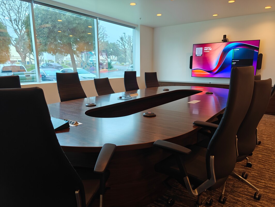 Finished boardroom with conference camera and touch panel